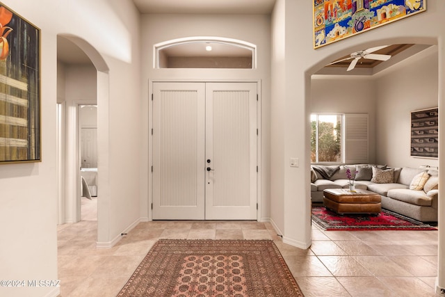 entrance foyer with a towering ceiling and ceiling fan