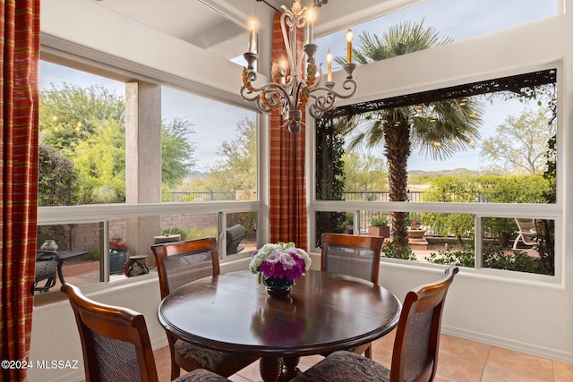 sunroom / solarium featuring a notable chandelier