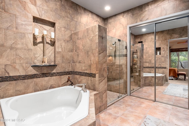 bathroom featuring tile walls and shower with separate bathtub