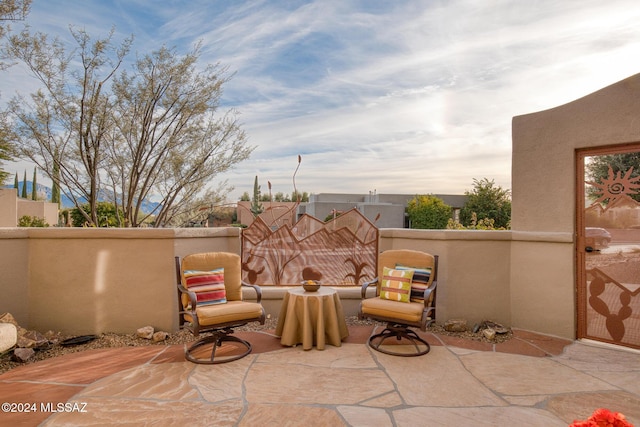 view of patio terrace at dusk