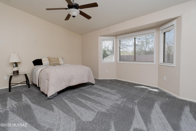 bedroom featuring ceiling fan and dark carpet