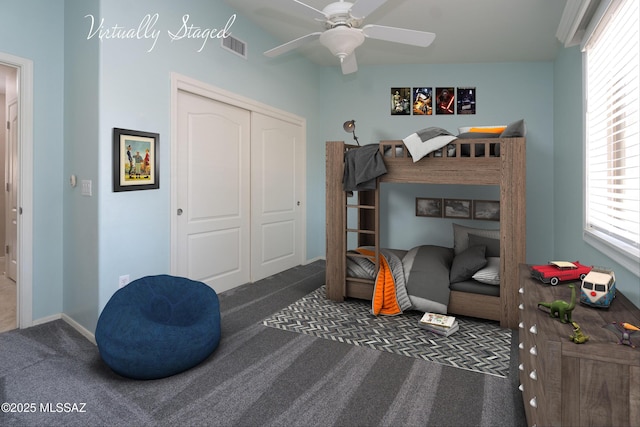 carpeted bedroom featuring a closet and ceiling fan