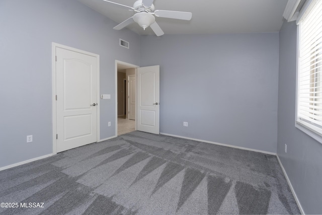 empty room featuring ceiling fan and carpet floors