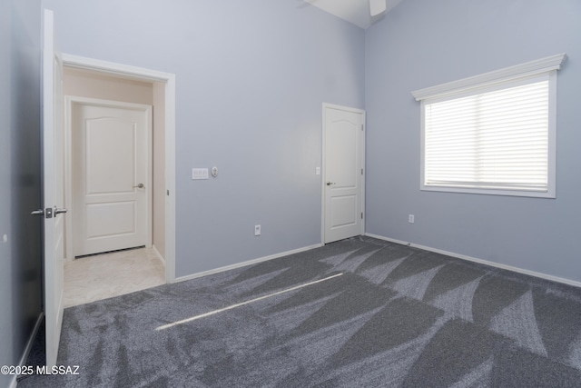 spare room featuring dark carpet