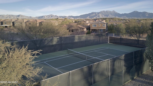 view of tennis court featuring a mountain view