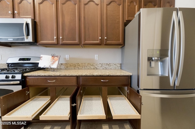 kitchen with stainless steel fridge with ice dispenser and white gas range oven