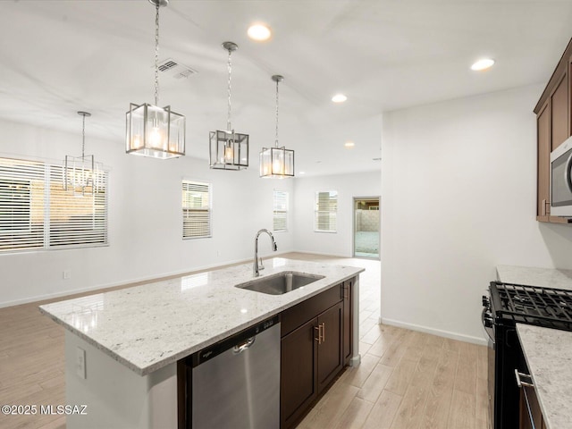 kitchen featuring a sink, a wealth of natural light, stainless steel appliances, and visible vents