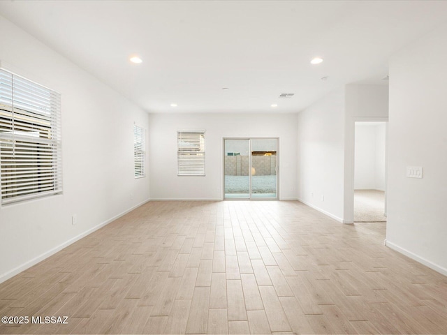 empty room with recessed lighting, visible vents, baseboards, and light wood-style floors