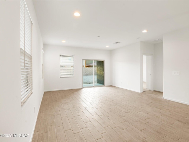 unfurnished room with recessed lighting, visible vents, baseboards, and light wood-type flooring