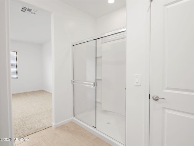 bathroom featuring visible vents, a shower stall, recessed lighting, and baseboards