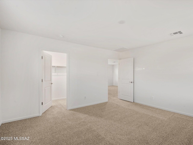 unfurnished room with visible vents, baseboards, and carpet floors