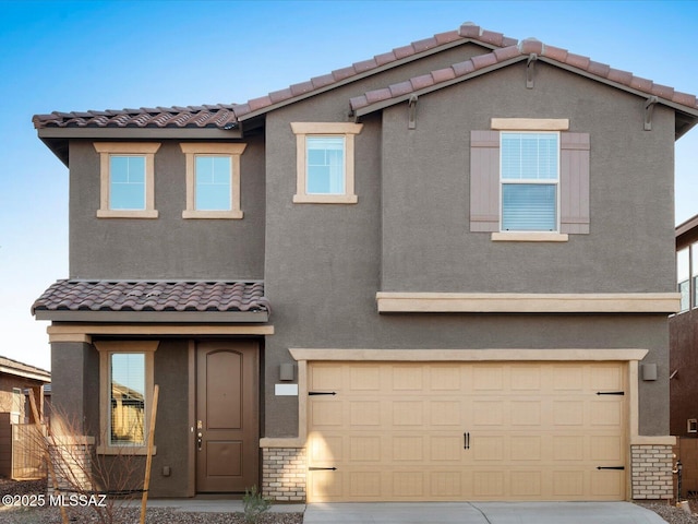 traditional-style house with stucco siding, driveway, a tiled roof, and an attached garage