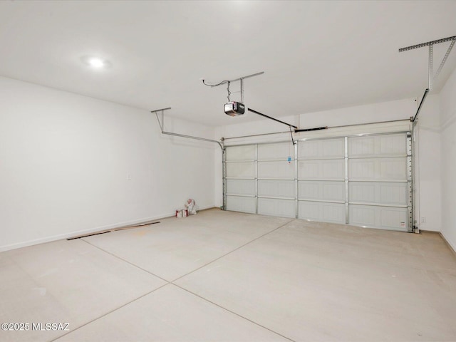 garage with a garage door opener and baseboards