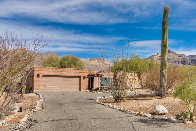 view of front of house with a garage and a mountain view