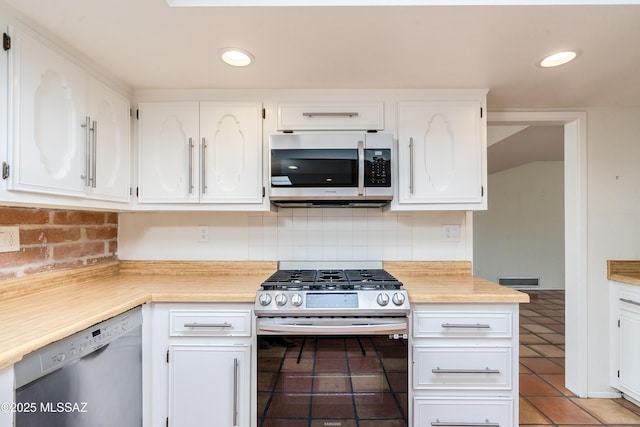 kitchen with white cabinetry, tasteful backsplash, stainless steel appliances, and light tile patterned flooring