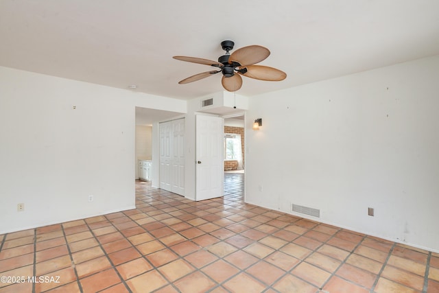 spare room featuring ceiling fan and light tile patterned flooring