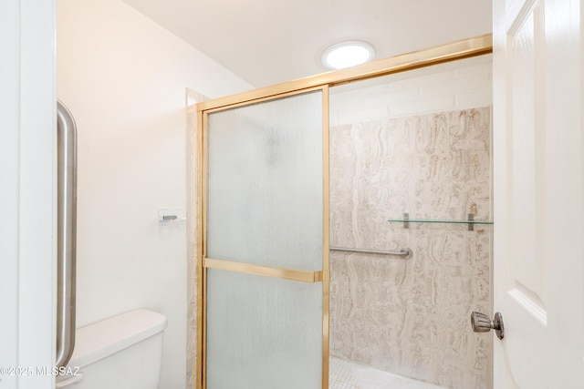 bathroom with toilet and a shower with shower door