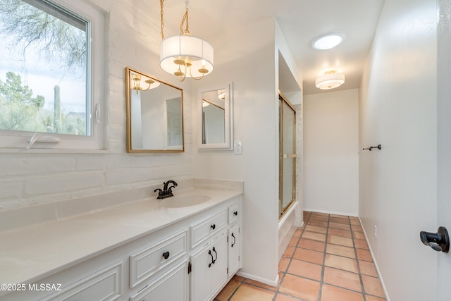 bathroom featuring vanity, shower / bath combination with glass door, and tile patterned flooring