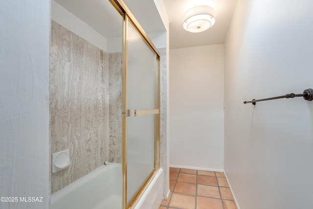 bathroom with tile patterned flooring and bath / shower combo with glass door