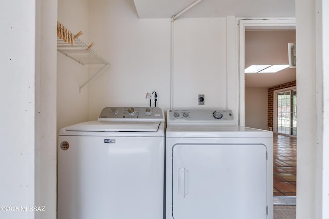 clothes washing area with washer and clothes dryer