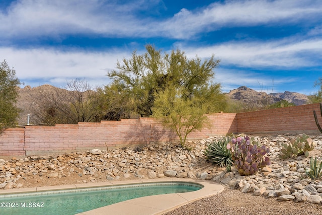 view of swimming pool featuring a mountain view