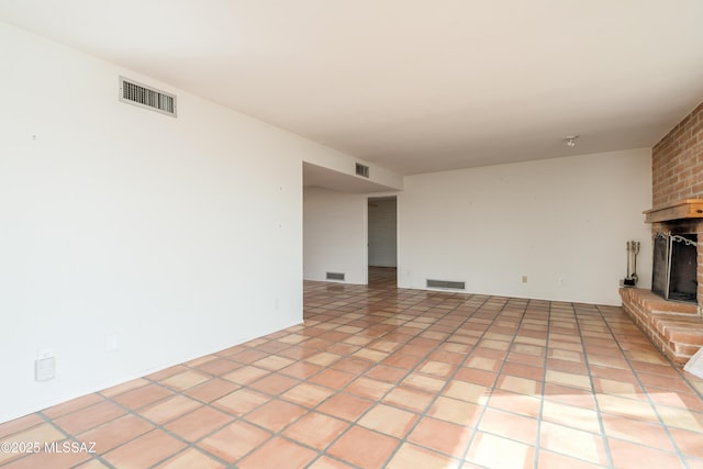 unfurnished living room featuring light tile patterned floors and a fireplace