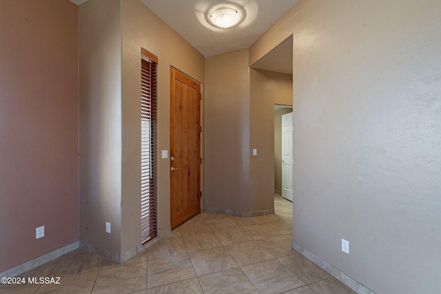 corridor featuring light tile patterned floors