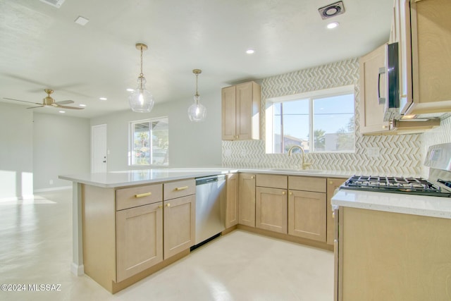 kitchen featuring kitchen peninsula, plenty of natural light, stainless steel dishwasher, and light brown cabinets