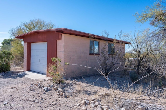 view of home's exterior with an outdoor structure and a garage