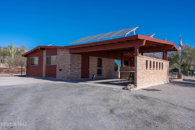 view of side of property featuring solar panels and a patio