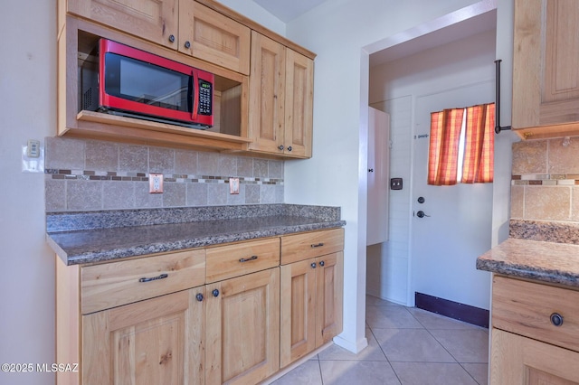 kitchen with light brown cabinets, backsplash, and light tile patterned floors