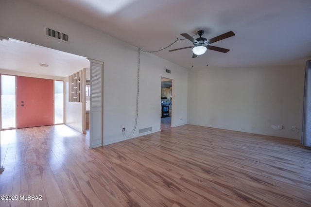 unfurnished living room featuring ceiling fan and light hardwood / wood-style flooring