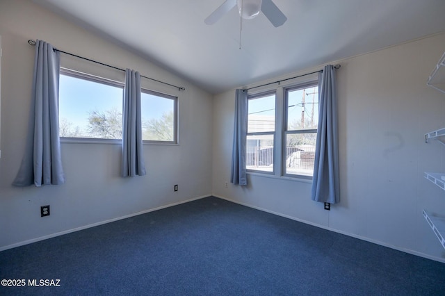 carpeted spare room featuring ceiling fan and lofted ceiling