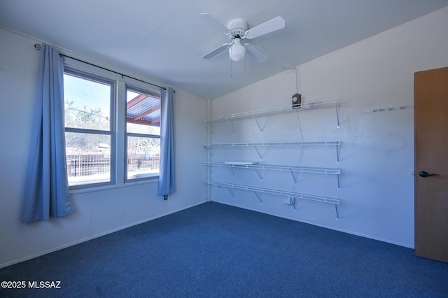 spare room with dark carpet and ceiling fan