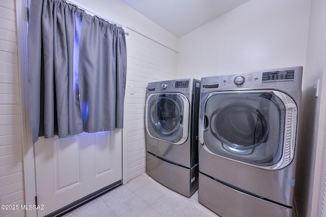 clothes washing area featuring separate washer and dryer