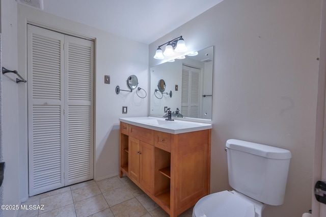 bathroom with tile patterned floors, vanity, and toilet