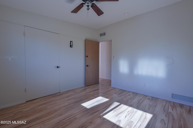 unfurnished bedroom featuring ceiling fan, a closet, and light hardwood / wood-style floors