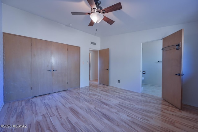 unfurnished bedroom featuring a closet, light hardwood / wood-style floors, and ceiling fan