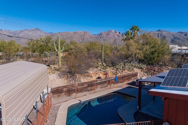 view of pool featuring a mountain view and a patio area