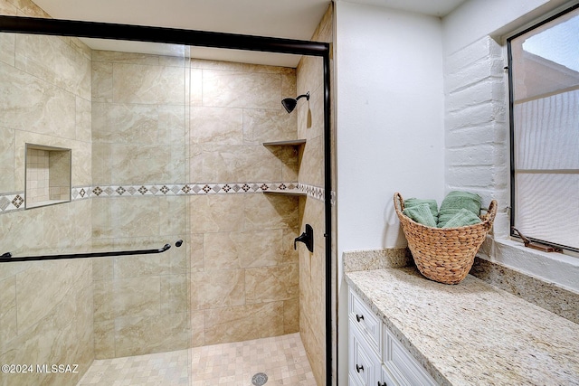 bathroom featuring a shower with shower door