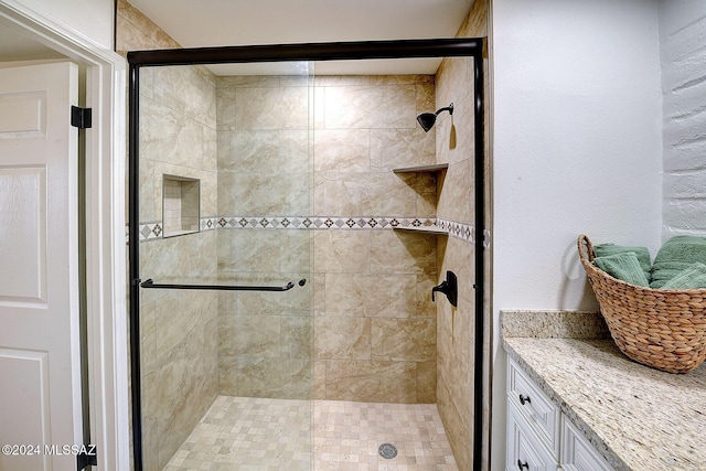 bathroom with a shower with door