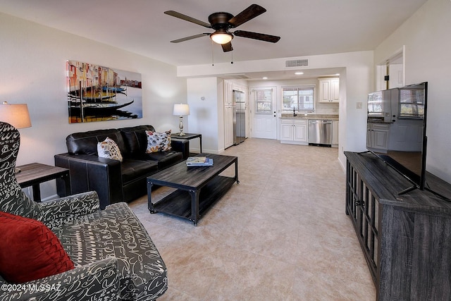 living room with ceiling fan and light tile patterned flooring