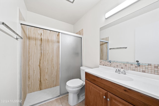 bathroom with tasteful backsplash, tile patterned floors, toilet, vanity, and a shower with shower door