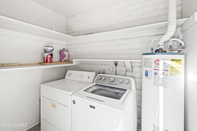 clothes washing area featuring washing machine and clothes dryer and gas water heater