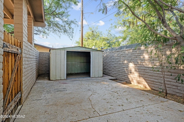 view of patio featuring a shed