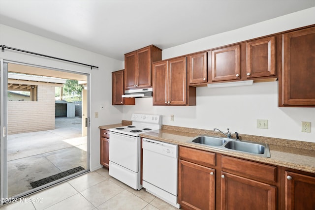 kitchen with light tile patterned flooring, white appliances, and sink