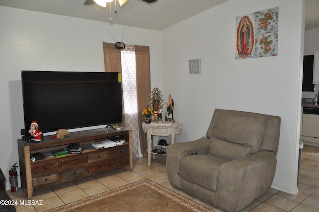 sitting room with ceiling fan and light tile patterned flooring