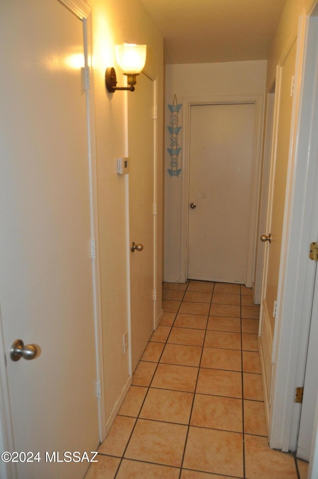 hall featuring light tile patterned flooring