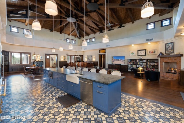 interior space with blue cabinetry, sink, and high vaulted ceiling