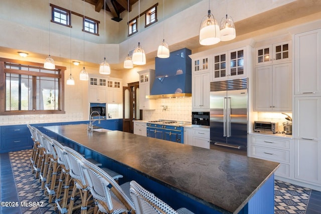 kitchen featuring blue cabinetry, white cabinets, and stainless steel appliances